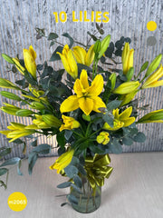 Arreglo Floral de Lilies Amarillos en Cilindro de Vidrio Alto con Follaje Dólar